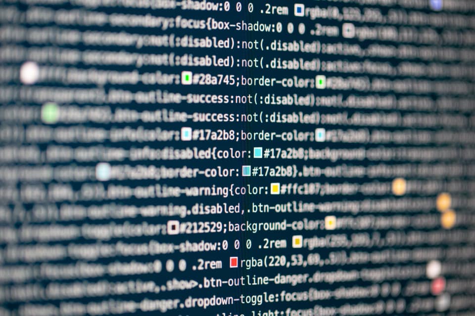 Security analyst watching network traffic graphs on a monitor