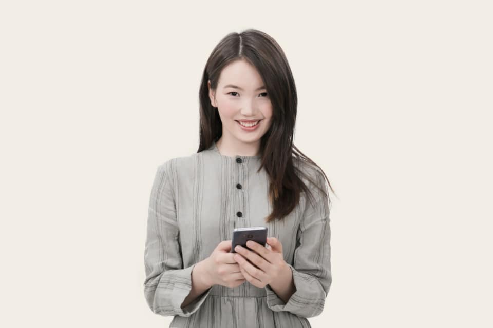 Commuter browsing an online shop on a phone while on a train