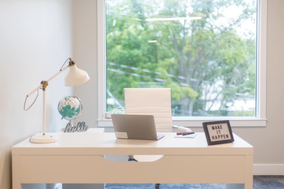 Freelancer managing client hosting accounts at a home office desk