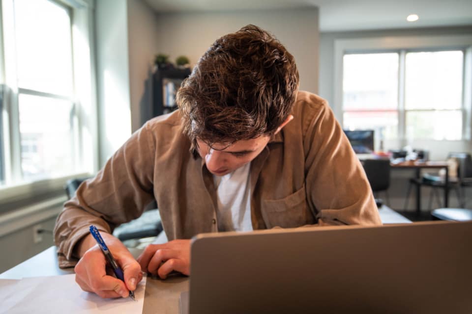 Engineer working across Windows and Linux systems in an office